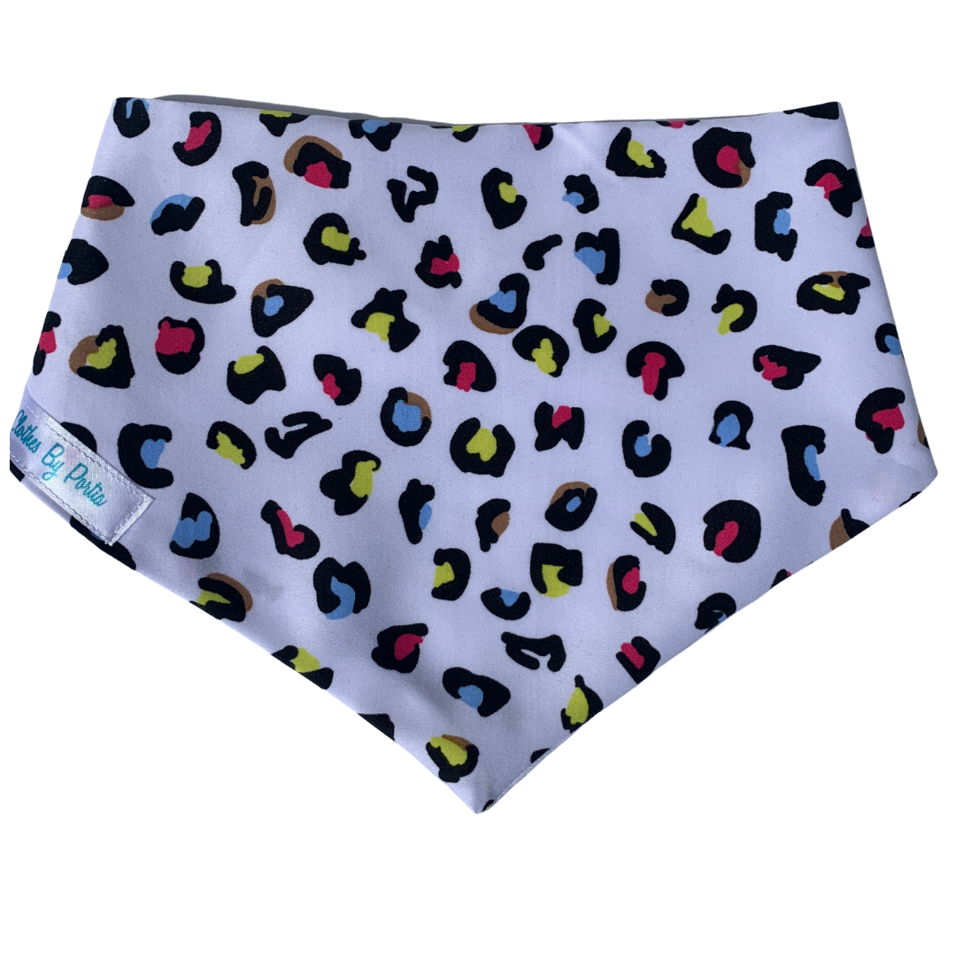 leopard print dog bandana with white background and bright blue, pink and yellow spots made in New Zealand